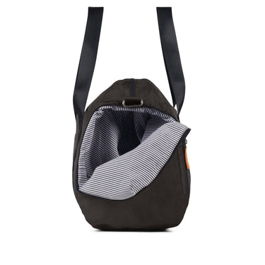 Black pet carrier with striped lining on a white background